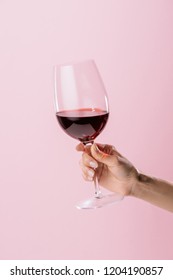 Cropped Shot Of Woman Holding Glass Of Red Wine Isolated On Pink