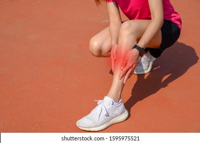 Cropped Shot Of Woman Runner Suffering Pain From Shin Splint. It Often Happens In The Front Or Inside Of The Lower Leg From Overtraining. Conceptual Of Common Running Injuries.