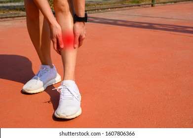 Cropped Shot Of Woman Runner Suffering Pain From Shin Splint. It Often Happens In The Front Or Inside Of The Lower Leg From Overtraining. Conceptual Of Common Running Injuries.