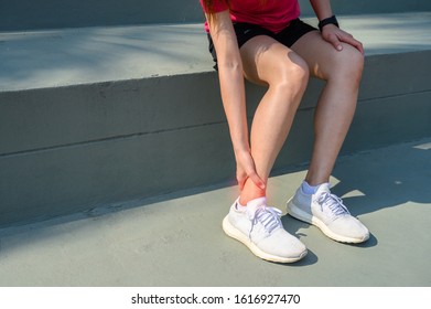 Cropped Shot Of Woman Runner Suffering From Ankle Pain. Ankle Pain May Be Caused By An Injury, Like A Sprain, Or By A Medical Condition, Such As Arthritis.