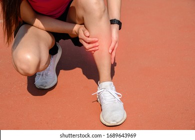 Cropped Shot Of Woman Runner Suffering Pain From Shin Splint. It Often Happens In The Front Or Inside Of The Lower Leg From Overtraining. Conceptual Of Common Running Injuries.