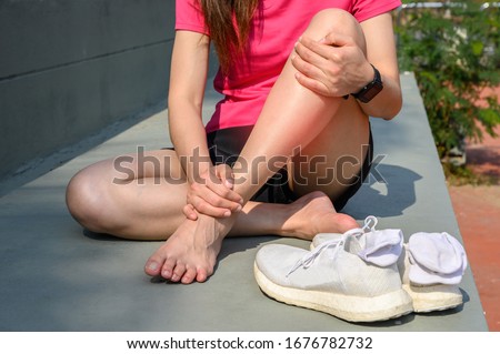 Cropped shot of woman runner suffering pain from Shin splint. It often happens in the front or inside of the lower leg from overtraining. Conceptual of common running injuries.