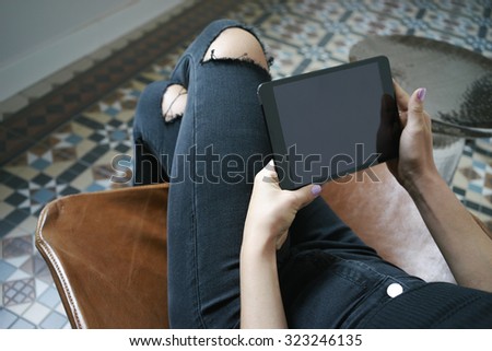 Cropped shot of a woman's hands using a digital tablet 