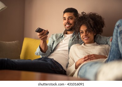 Cropped shot of a young african american couple watching television at home - Shutterstock ID 431016091