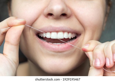 A Cropped Shot Of A Young Beautiful Woman Flossing Her Teeth. Close-up. Dental Concept