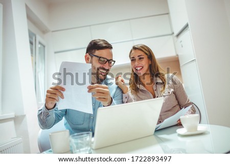 Cropped shot of a young couple using a laptop while going over their finances at home. Paying bills is easy when you're doing it online. Planning budget for home renovation