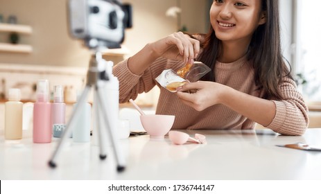 Cropped shot of young female blogger recording a tutorial video for her beauty blog about skincare. Vlogger testing eye patch, recording video for social network. Blogging, Work from Home concept
