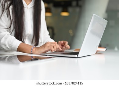 Cropped Shot Of Young Female Free Lancer Hands Typing On Computer Laptop On White Desk.