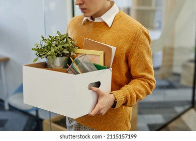 Cropped Shot Of Young Man Carrying Box Of Personal Belongings Starting New Job In Office, Copy Space