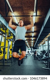 Cropped shot of a young muscular man doing pull ups - Shutterstock ID 1046173894