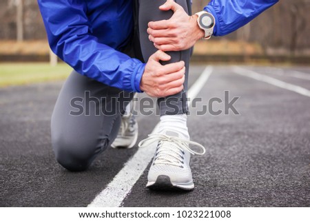 Cropped shot of a young runner holding his leg in pain. Shin splints.