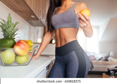 Cropped shot of young woman eating fruit for breakfast.