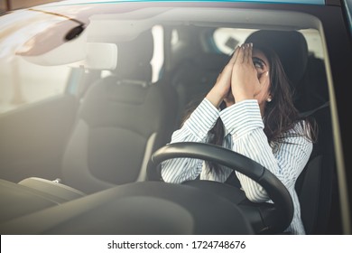 Cropped Shot Of A Young Woman Looking Stressed-out While Sitting In Her Car. Stressed Woman Driver. Transportation Concept. Sad Businesswoman Driver Sitting In Car