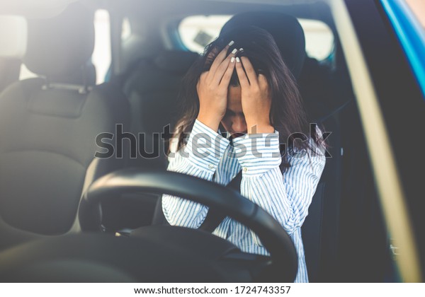 Cropped shot of a\
young woman looking stressed-out while sitting in her car. Stressed\
woman driver. Transportation concept. Sad businesswoman driver\
sitting in car