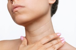 Cropped Shot Of A Young Woman Touching Her Neck With Her Hand Isolated On A White Background. Lines On The Neck. Wrinkles, Age-related Changes, Rings Of Venus, Goosebumps