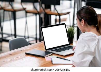 Cropped Shot Of Young Woman Working On Laptop Computer, Mockup Blank Screen For Product Display Or Graphic Design.