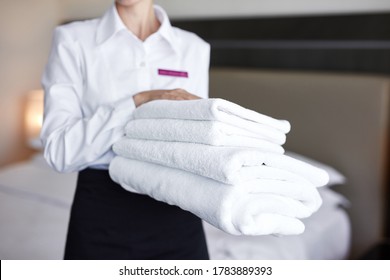 Cropped Unrecognizable Maid With White Towels In Hands, Close-up Photo Of Towels, Hotel Staff