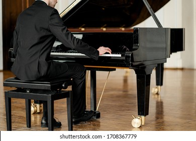 Cropped Unrecognizable Male In Suit Playing Piano On A Stage. Handsome Guy Gracefully Play Piano, Practice Before Performance