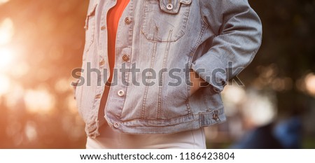 Similar – Frau mit Jeansjacke, blauer Bluse und silberner Armbanduhr.