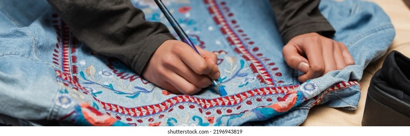 Cropped View Of African American Craftswoman Painting On Denim Jacket With Embroidery, Banner