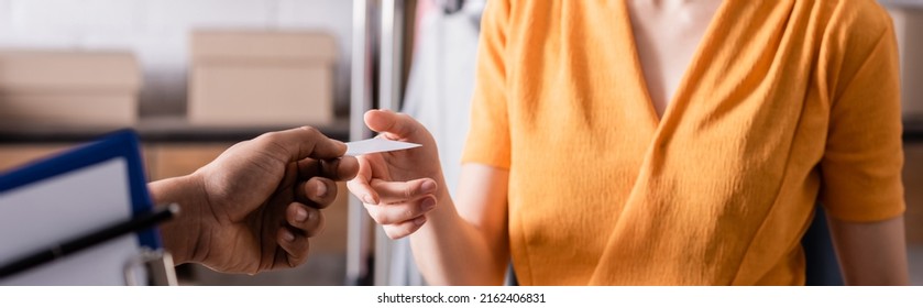 Cropped View Of African American Deliveryman Holding Business Card Near Seller In Online Web Store, Banner