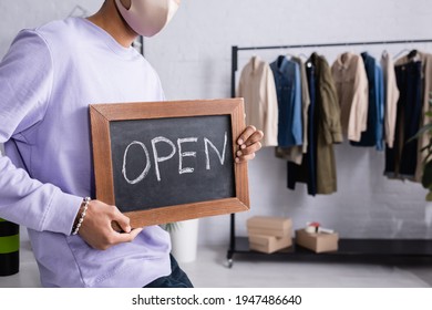 Cropped View Of African American Small Business Owner In Protective Mask Holding Chalkboard With Open Lettering