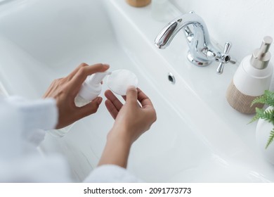 Cropped View Of African American Woman Holding Bottle With Cleanser And Cotton Pad Near Sink