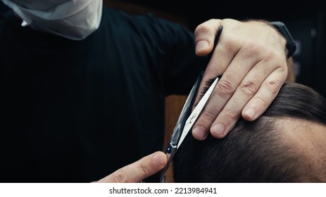 Cropped View Of Barber In Medical Mask Cutting Hair Of Man In Barbershop