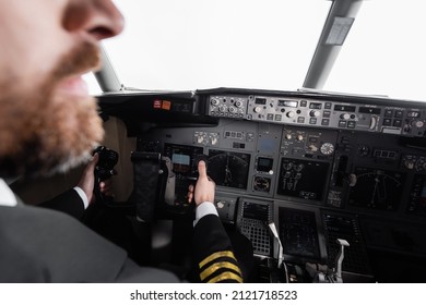 Cropped View Of Bearded Pilot Using Yoke In Airplane Simulator