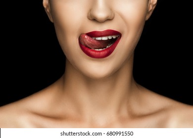 Cropped View Of Beautiful Woman Licking Lips With Red Lipstick, Isolated On Black