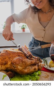 Cropped View Of Blurred African American Woman Cutting Delicious Turkey At Home