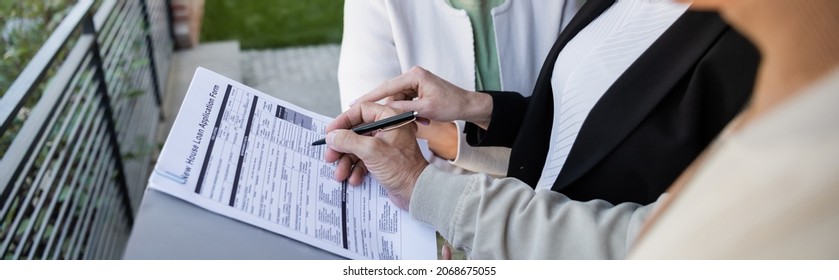 Cropped View Of Blurred Man Signing Loan Application Near Wife And Realtor, Banner