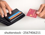 Cropped view of businessman giving credit card from wallet on table