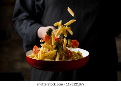 Cropped view of chef cooking Italian pasta with cheese, vegetabl - Shutterstock ID 1173121879