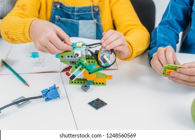 Cropped View Of Children Working Together On STEM Project In Classrom