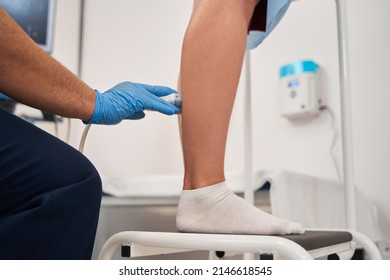 Cropped View Of The Doctor Doing Ultrasound Examination Of Patient's Leg Veins