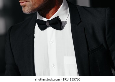 Cropped View Of Elegant Man In Black And Bow Tie. Concept Of Men Stylish Elegance Clothes With Place For Your Text. High Quality Photo