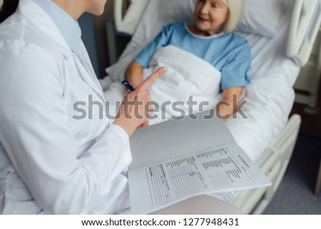 Similar – Doctor giving a prescription to senior patient