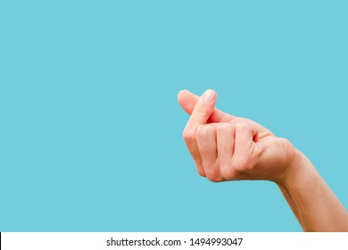 cropped view of female hand snapping fingers isolated on blue - Shutterstock ID 1494993047