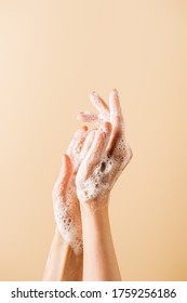 Cropped View Of Female Hands In Soap Foam Isolated On Beige