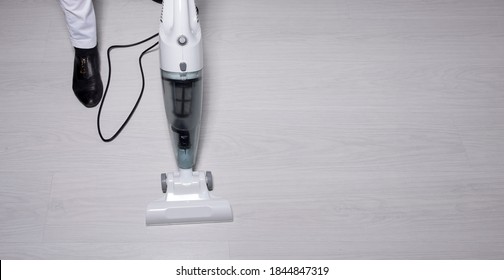 Cropped View Of Female Legs With Vacuum Cleaner. Vacuuming Floor. Сleaning Hospital During An Epidemic Covid 19. Copy Space