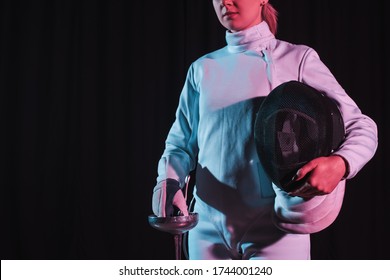 Cropped View Of Fencer Holding Rapier And Fencing Mask Isolated On Black