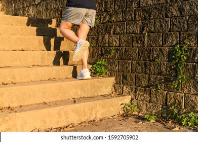 Cropped View Of Fitness Runner Woman Training Herself By Running Up Steps On Staircase In Urban Street. Uphill Running Can Improve Average Running Speed And Your Step Length Greater Benefit.