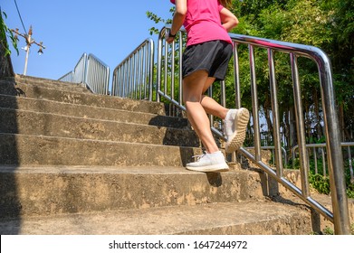 Cropped View Of Fitness Runner Woman Training Herself By Running Up Steps On Staircase In Urban Street. Uphill Running Can Improve Average Running Speed And Your Step Length Greater Benefit.