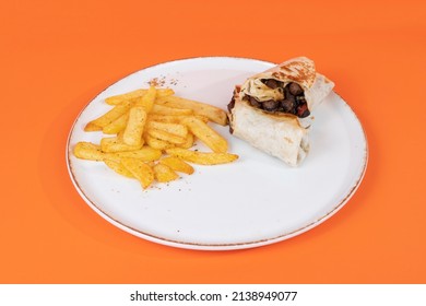 Cropped view of flaked wrap and french fries plate shot from side or angle with selective focus on isolated setting, orange background.