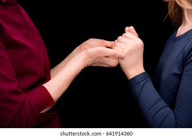 Cropped View Of Grandchild And Grandmother Holding Hands Isolated On Black 