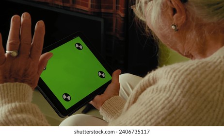 Cropped view of the happy loving older family spouses waving at computer green screen - Powered by Shutterstock