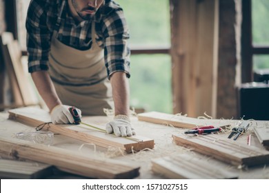 Cropped view of his he nice attractive focused experienced professional guy expert measuring plank board creating house project start-up at modern industrial loft style interior indoors