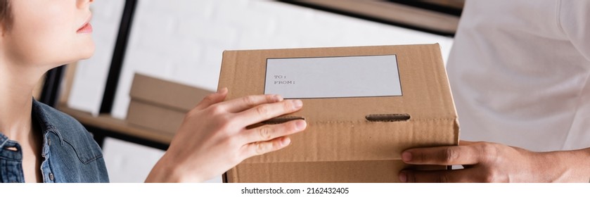 Cropped View Of Interracial Sellers Holding Carton Box With Shipping Label In Online Web Store, Banner