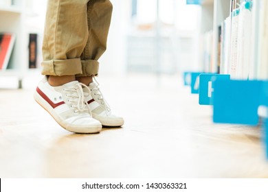 Cropped View Of Kid Standing On Tip Toe In White Sneakers 